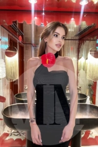 Dubai escort Agata wearing a black dress at a restaurant