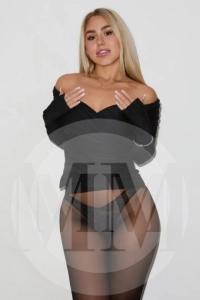 Britney wearing a black top and see through tights that reveal her lacy black panties.