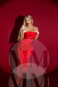 Carmen wearing a long silk red dress