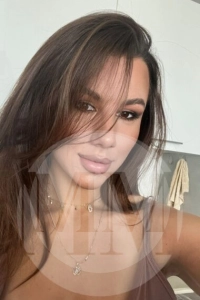 Crystal taking a selfie with some hair in front of her eyes and a soft expression.