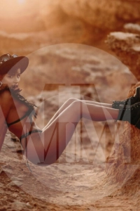 Madrid escort India in the desert wearing a black bikini