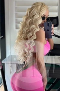 London escort Krissy taking a selfie in a pink outfit
