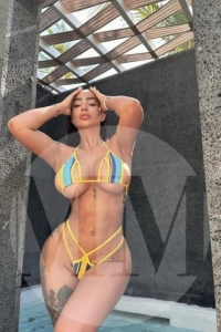 Dubai escort Mina wearing a blue and yellow bikini