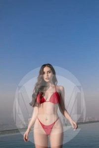 Dubai escort Tessy in a pool wearing a red bikini