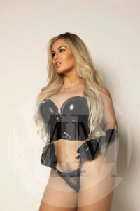 London escort Zaya wearing a latex black bra