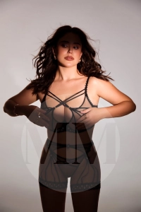 Ariana wearing black strappy and lacey lingerie.